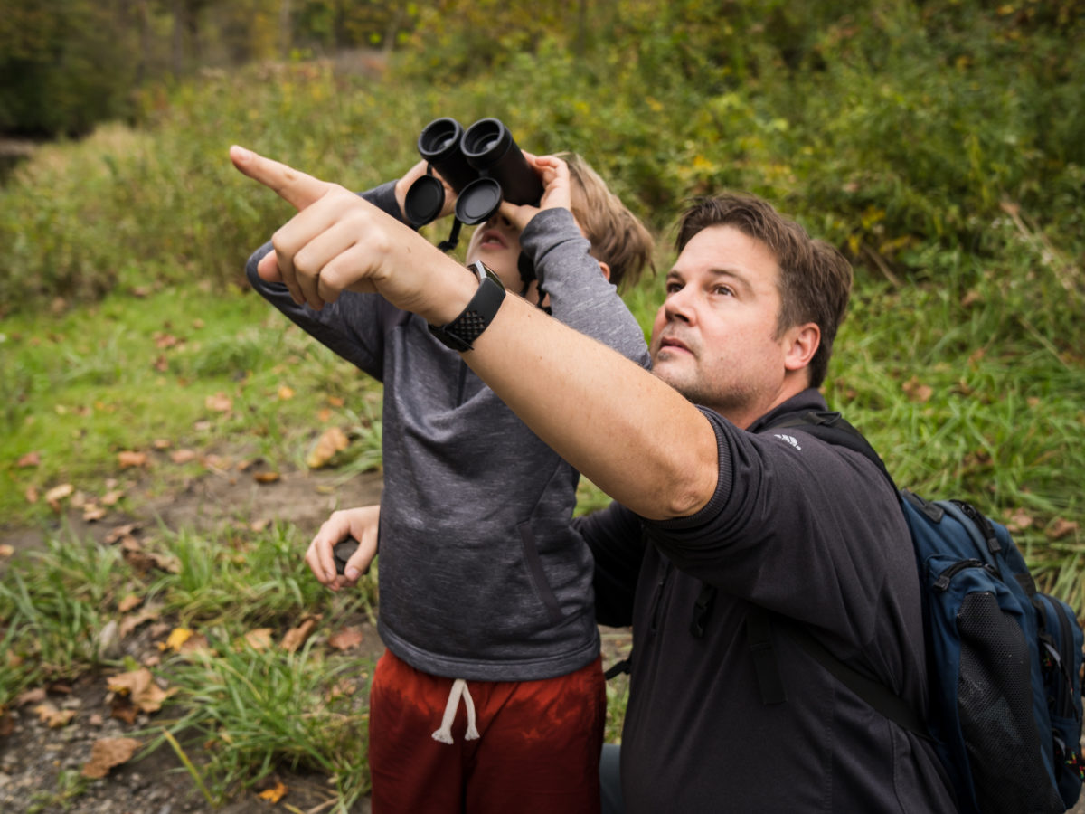 Father and son with binoculars